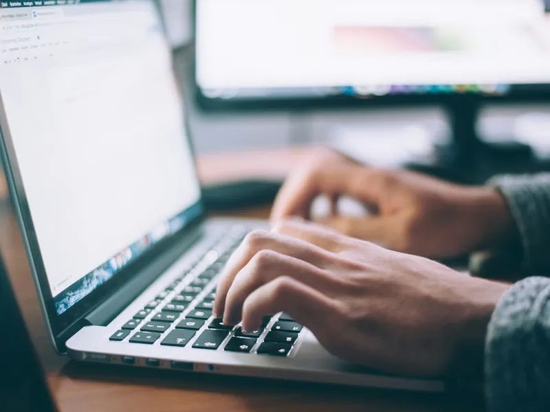 Hands on a laptop keyboard, LangChain work in progress